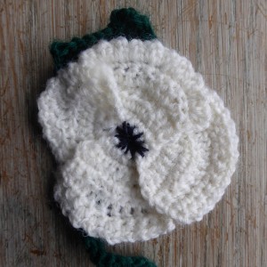 A crocheted white poppy